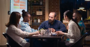 Diverse coworkers brainstorming, team leader explaining strategy plan