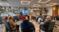 Older and younger participants seated in a circle during a group storytelling session.