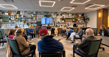 Older and younger participants seated in a circle during a group storytelling session.