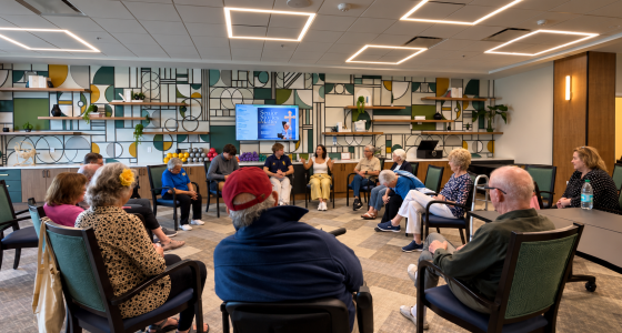 Older and younger participants seated in a circle during a group storytelling session.