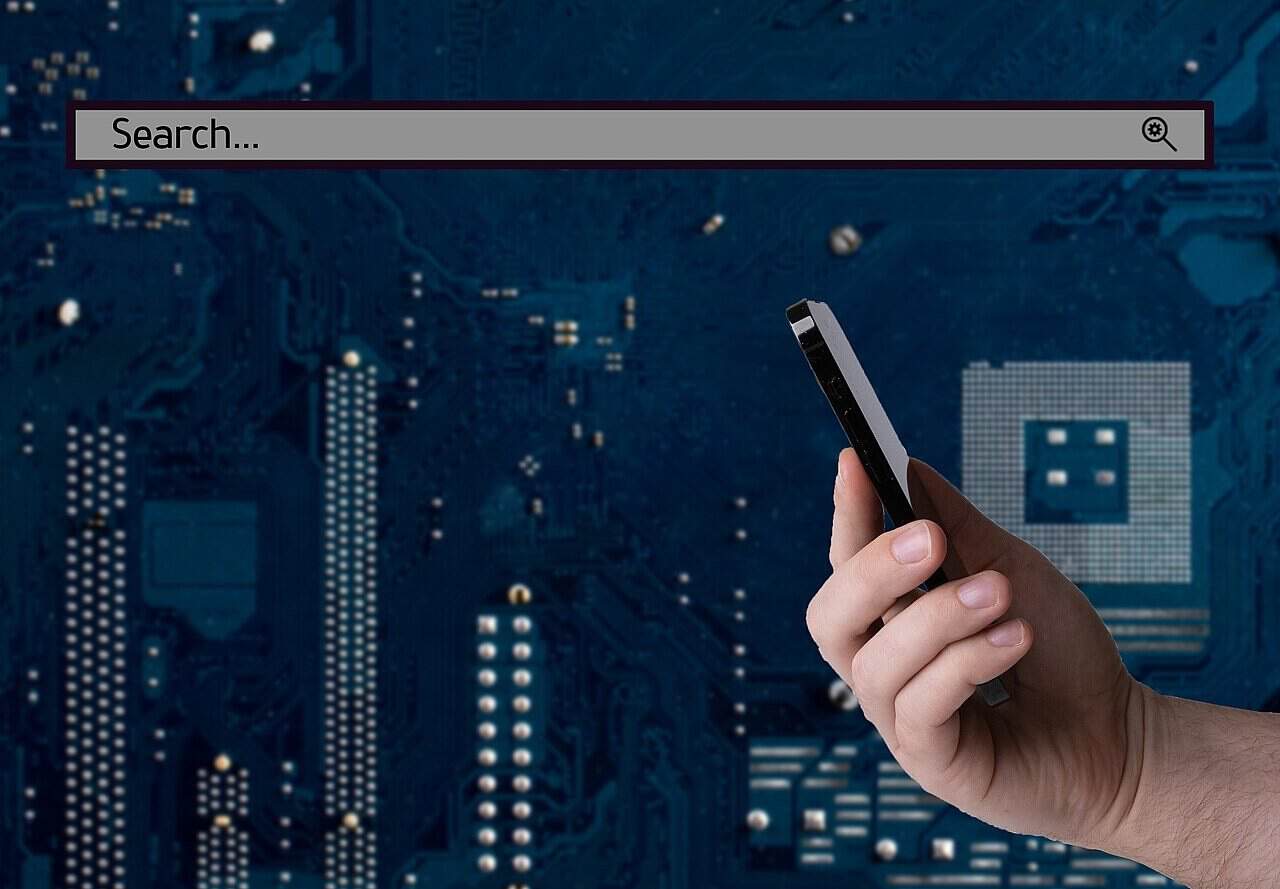 Business and technology concept hand holding smartphone and search bar